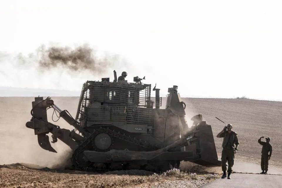 An Israeli D9 Bulldozer rolls along the southern Israeli border with the Gaza Strip (AFP via Getty Images)